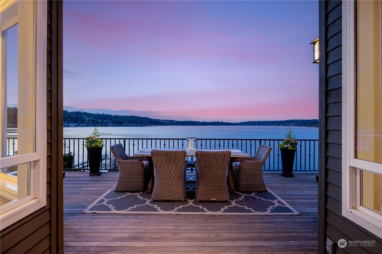 Waterfront deck at dusk with Lake Washington and the Eastside hills beyond